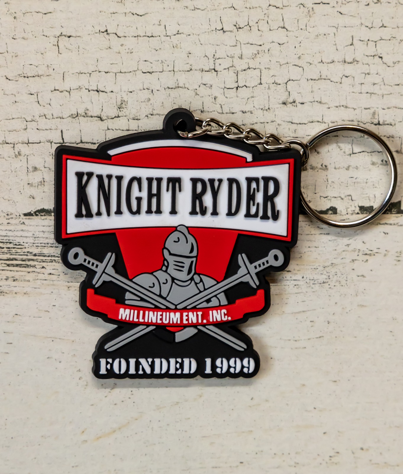 A keychain that says knight ryder, founded 1 9 9 9.